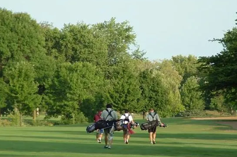 golfers walking on fairway