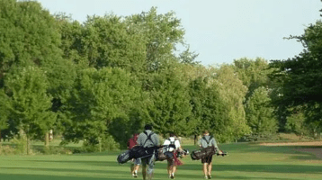 golfers walking on fairway